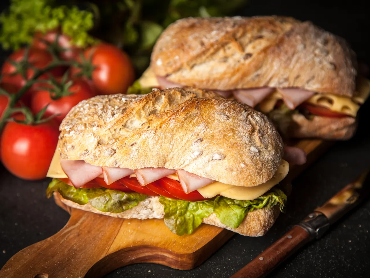 Two fresh submissions for Sandwich Fest laid out on a cutting board ready for a photo shoot